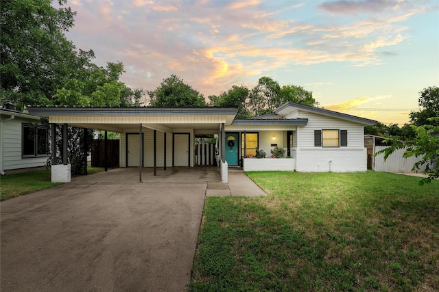 1905 S 51st St, Temple, TX 76504 - back of house at dusk featuring concrete driveway and an attached carport