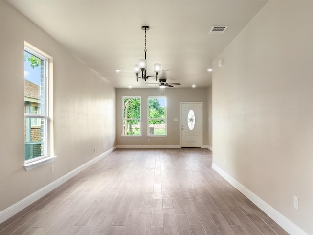 1510 N Wilhite St, Cleburne, TX 76031 - unfurnished living room with a chandelier, healthy amount of natural light, and light wood-style flooring
