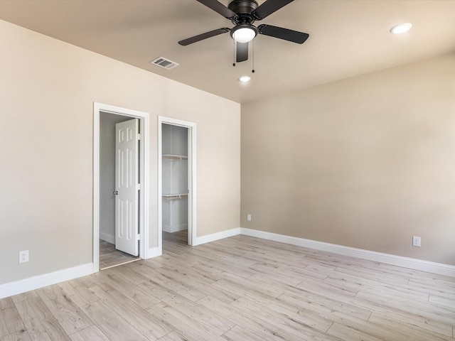 1510 N Wilhite St, Cleburne, TX 76031 - unfurnished bedroom featuring light wood-style floors, a spacious closet, recessed lighting, a closet, and a ceiling fan