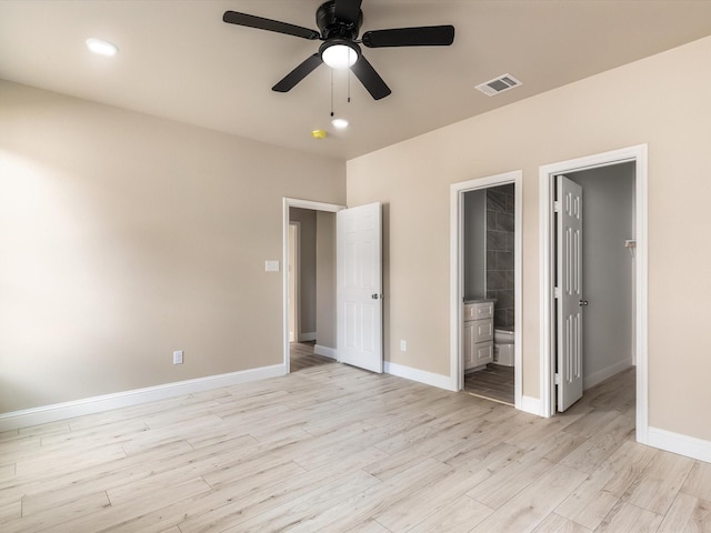 1510 N Wilhite St, Cleburne, TX 76031 - unfurnished bedroom featuring light wood-style floors, ensuite bathroom, a spacious closet, ceiling fan, and recessed lighting