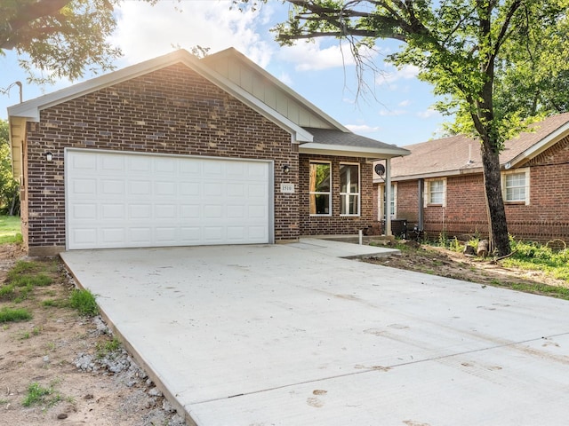 1510 N Wilhite St, Cleburne, TX 76031 - ranch-style home featuring brick siding, concrete driveway, a garage, and board and batten siding