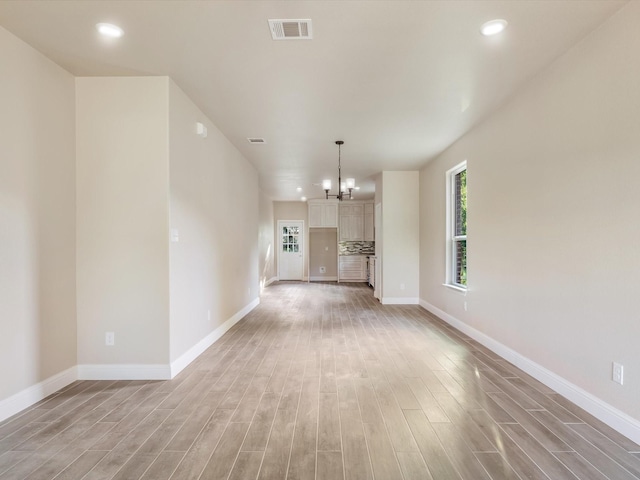 1510 N Wilhite St, Cleburne, TX 76031 - unfurnished living room featuring light wood finished floors, recessed lighting, and a chandelier