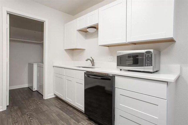 5020 Donnelly Ave Unit 5022, Fort Worth, TX 76107 - kitchen featuring dishwasher, washing machine and dryer, dark wood finished floors, light countertops, and white cabinets
