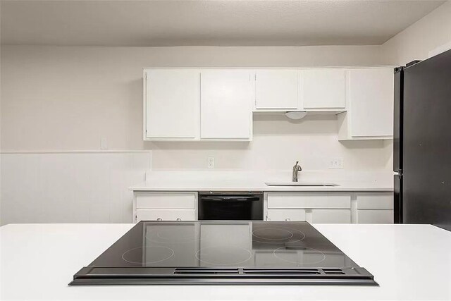 5020 Donnelly Ave Unit 5022, Fort Worth, TX 76107 - kitchen featuring black appliances, white cabinets, and light countertops
