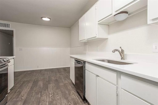 5020 Donnelly Ave Unit 5022, Fort Worth, TX 76107 - kitchen featuring appliances with stainless steel finishes, light countertops, wainscoting, white cabinets, and dark wood-type flooring
