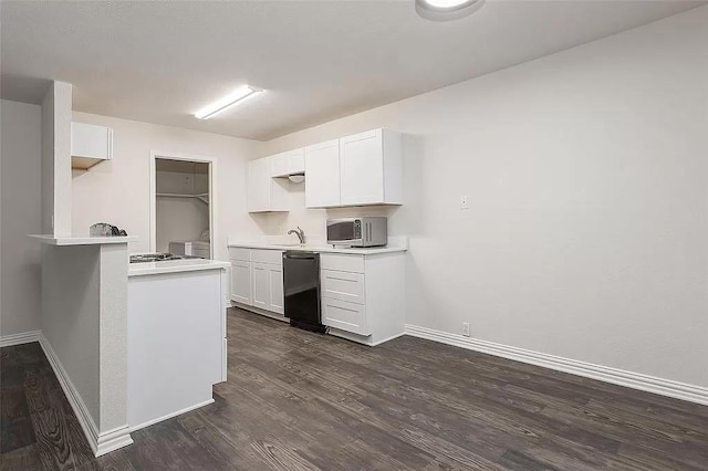 5020 Donnelly Ave Unit 5022, Fort Worth, TX 76107 - kitchen featuring dishwasher, dark wood-type flooring, light countertops, and white cabinetry