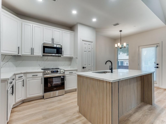 9816 Clocktower Ct, Plano, TX 75025 - kitchen featuring stainless steel appliances, light wood finished floors, backsplash, white cabinetry, and decorative light fixtures