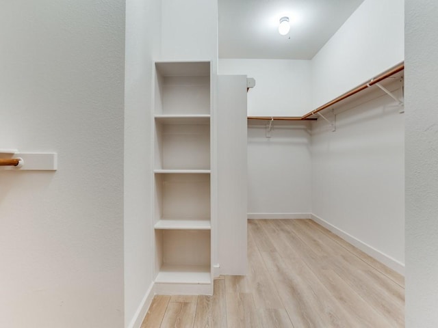 9816 Clocktower Ct, Plano, TX 75025 - walk in closet featuring wood finished floors