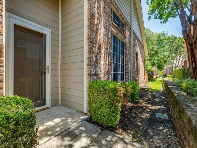 9816 Clocktower Ct, Plano, TX 75025 - doorway to property featuring brick siding