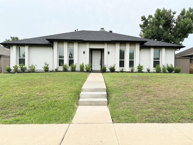 1722 Brighton Dr, Carrollton, TX 75007 - prairie-style house featuring brick siding, a front yard, and roof with shingles