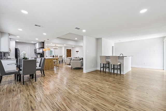 1722 Brighton Dr, Carrollton, TX 75007 - dining area with light wood finished floors and recessed lighting