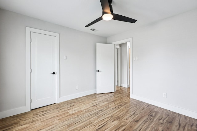 1722 Brighton Dr, Carrollton, TX 75007 - unfurnished bedroom featuring light wood-style floors and ceiling fan