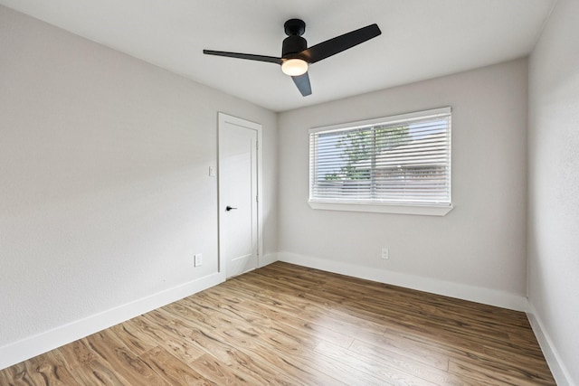 1722 Brighton Dr, Carrollton, TX 75007 - unfurnished room featuring wood finished floors and ceiling fan