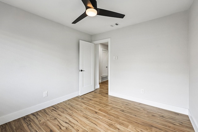 1722 Brighton Dr, Carrollton, TX 75007 - unfurnished room featuring wood finished floors and ceiling fan