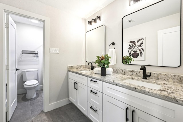 1722 Brighton Dr, Carrollton, TX 75007 - bathroom featuring double vanity and toilet