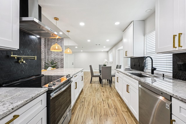 1722 Brighton Dr, Carrollton, TX 75007 - kitchen with appliances with stainless steel finishes, wall chimney exhaust hood, backsplash, light wood-type flooring, and white cabinetry
