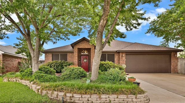 529 Cambridge Dr, Saginaw, TX 76179 - view of front of house featuring an attached garage, driveway, brick siding, and roof with shingles