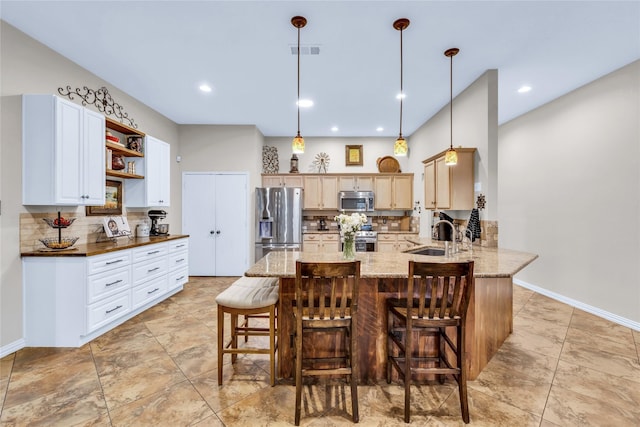 529 Cambridge Dr, Saginaw, TX 76179 - kitchen with appliances with stainless steel finishes, a peninsula, tasteful backsplash, light stone counters, and recessed lighting