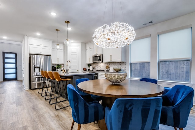 2413 Latimer Mews, Celina, TX 75009 - dining space with light wood-style flooring, a chandelier, and recessed lighting