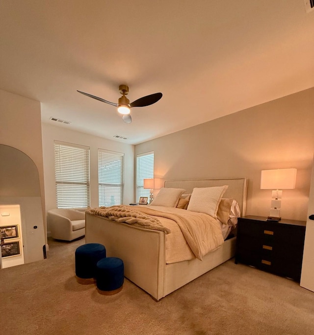 2413 Latimer Mews, Celina, TX 75009 - bedroom featuring light colored carpet, ceiling fan, and arched walkways