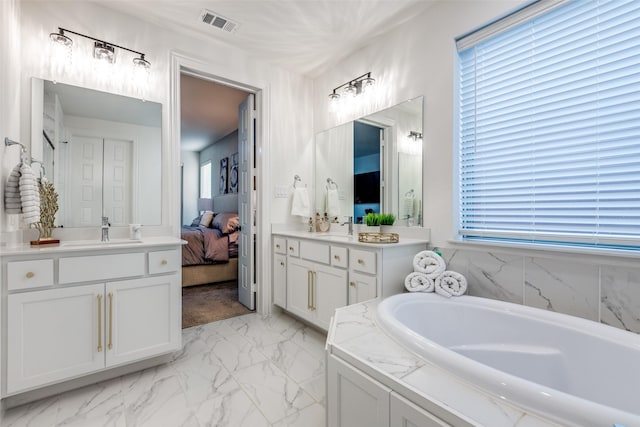 2413 Latimer Mews, Celina, TX 75009 - full bathroom with a garden tub, two vanities, marble finish flooring, and connected bathroom
