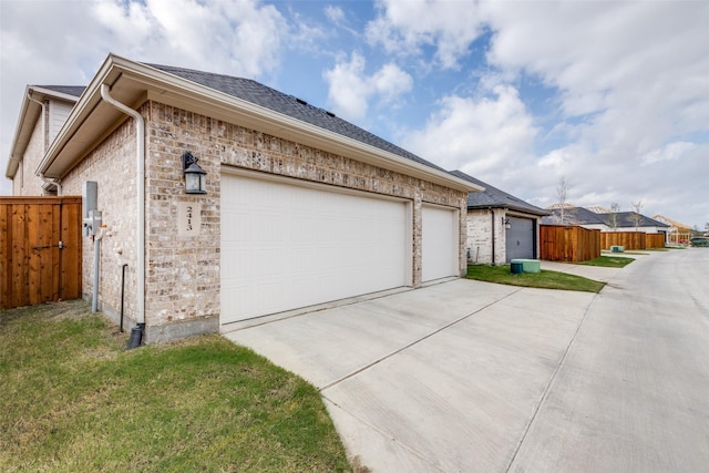 2413 Latimer Mews, Celina, TX 75009 - view of side of property featuring driveway, an attached garage, and roof with shingles