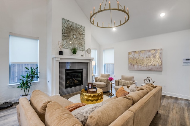 2413 Latimer Mews, Celina, TX 75009 - living area featuring wood finished floors, high vaulted ceiling, a chandelier, a fireplace, and healthy amount of natural light