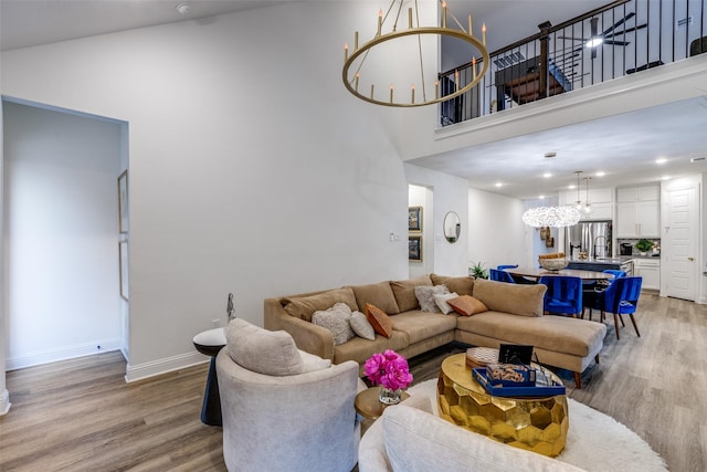 2413 Latimer Mews, Celina, TX 75009 - living area featuring a chandelier, light wood-style floors, a high ceiling, and recessed lighting