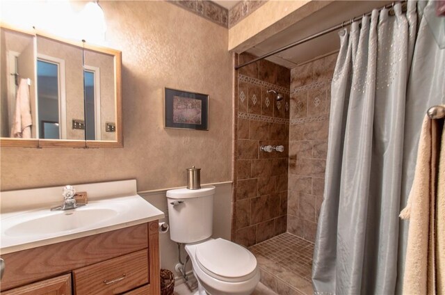 1002 Hawthorne Dr, Allen, TX 75002 - bathroom featuring vanity, a textured wall, and a tile shower