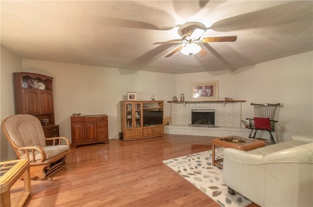 1002 Hawthorne Dr, Allen, TX 75002 - living room featuring ceiling fan, wood finished floors, and a brick fireplace