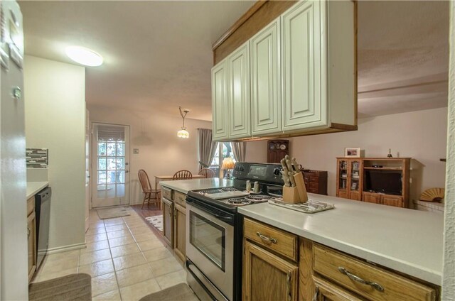 1002 Hawthorne Dr, Allen, TX 75002 - kitchen featuring appliances with stainless steel finishes, plenty of natural light, light tile patterned floors, and light countertops