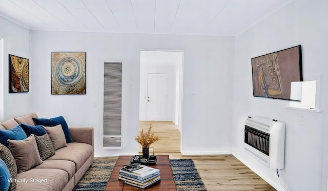 107 Quillen, Whitesboro, TX 76273 - living room with heating unit, a heating unit, wood finished floors, and crown molding