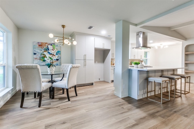 430 Cambridge Dr, Richardson, TX 75080 - dining space with a chandelier, light wood-style floors, healthy amount of natural light, and beamed ceiling