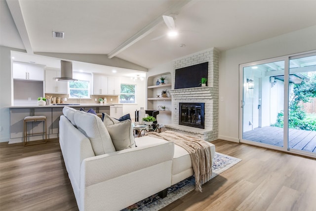 430 Cambridge Dr, Richardson, TX 75080 - living area featuring ceiling fan, light wood finished floors, and a fireplace