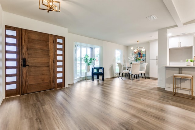 430 Cambridge Dr, Richardson, TX 75080 - foyer with a chandelier and light wood finished floors