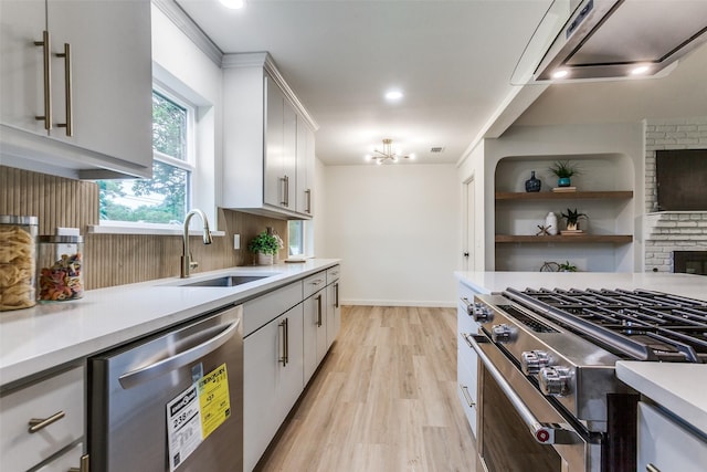 430 Cambridge Dr, Richardson, TX 75080 - kitchen with stainless steel appliances, light wood-style flooring, light countertops, ventilation hood, and decorative backsplash