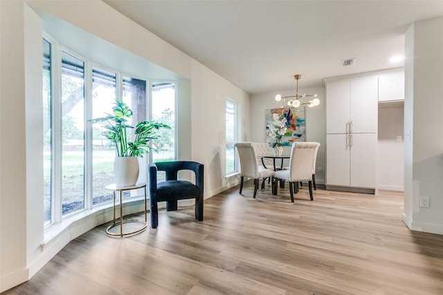 430 Cambridge Dr, Richardson, TX 75080 - dining room featuring light wood-style flooring and a chandelier