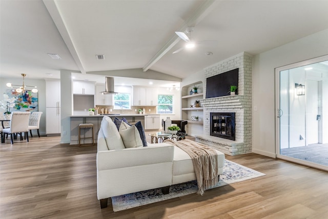 430 Cambridge Dr, Richardson, TX 75080 - living room with a ceiling fan, light wood-style floors, and a brick fireplace