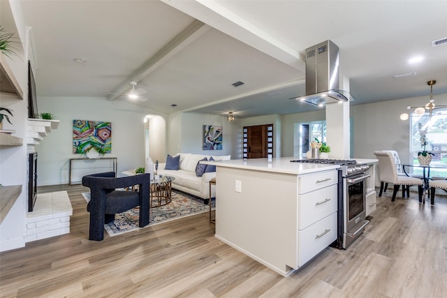 430 Cambridge Dr, Richardson, TX 75080 - kitchen featuring island exhaust hood, high end stove, light wood-type flooring, white cabinets, and open floor plan