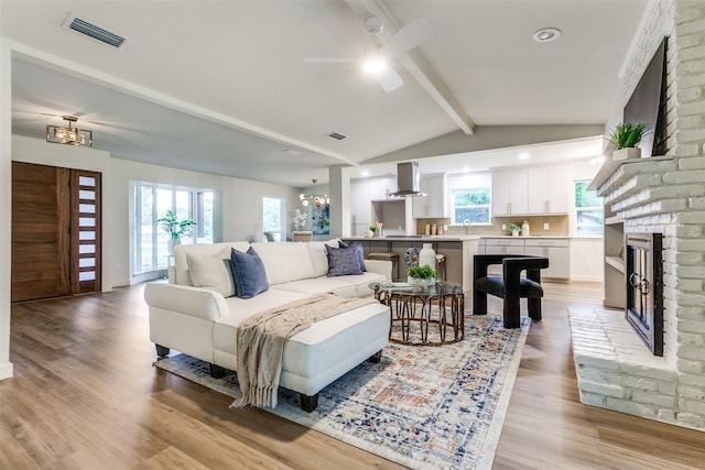 430 Cambridge Dr, Richardson, TX 75080 - living area with a fireplace, ceiling fan, light wood-type flooring, a chandelier, and recessed lighting