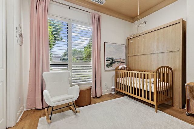 2157 Lookout Ct, Hurst, TX 76054 - bedroom featuring wood finished floors and a nursery area