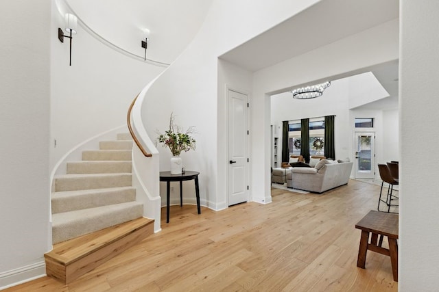 2157 Lookout Ct, Hurst, TX 76054 - foyer with light wood-style flooring, stairs, and a chandelier