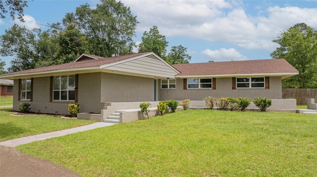 812 E 1st, Hughes Springs, TX 75656 - ranch-style home featuring brick siding and a front lawn