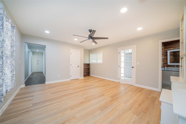 812 E 1st, Hughes Springs, TX 75656 - unfurnished living room featuring a ceiling fan, light wood-style floors, and recessed lighting