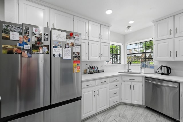 4003 Tuscany Ln, Arlington, TX 76016 - kitchen featuring stainless steel appliances, recessed lighting, light countertops, white cabinets, and light marble finish flooring