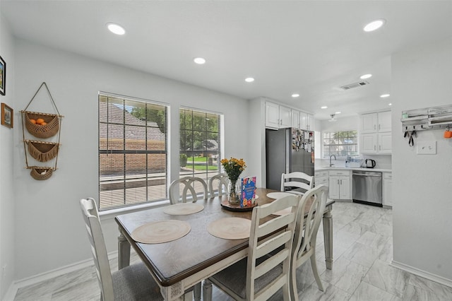 4003 Tuscany Ln, Arlington, TX 76016 - dining space with healthy amount of natural light, recessed lighting, and light marble finish flooring