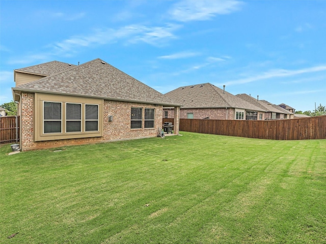 709 Providence, Wylie, TX 75098 - back of house with a shingled roof, a fenced backyard, and brick siding