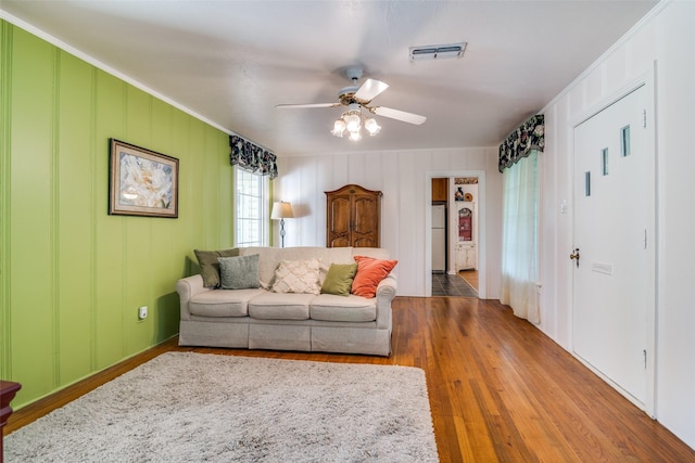1312 Linden Ln, Garland, TX 75040 - living room featuring ceiling fan, wood finished floors, and a decorative wall