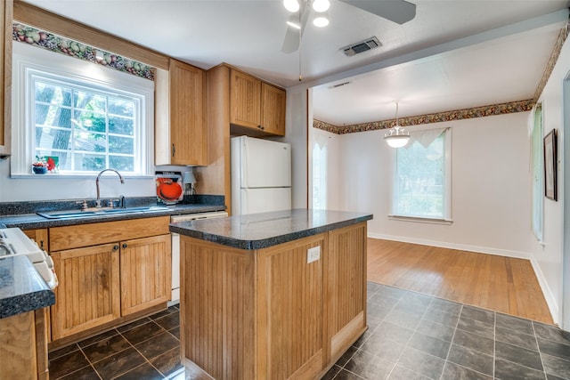 1312 Linden Ln, Garland, TX 75040 - kitchen featuring freestanding refrigerator, dishwasher, plenty of natural light, and dark countertops