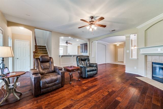 2748 Indian Oak Dr, Mckinney, TX 75071 - living area with a ceiling fan, decorative columns, hardwood / wood-style flooring, a tile fireplace, and arched walkways